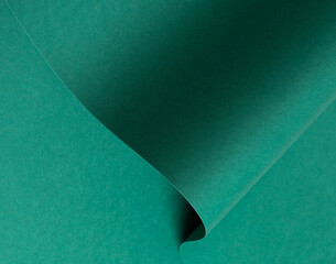Emerald green paper background with a matte finish and subtle wavy texture. Deep green tones create