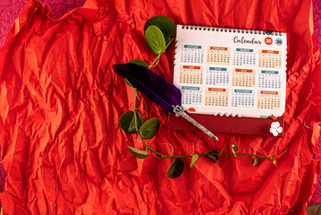 January 2025 desk calendar on red  textured background. 
