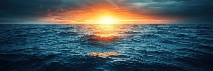 Obraz premium Golden sunlight reflects off the calm water as the day ends, creating a serene atmosphere at sea