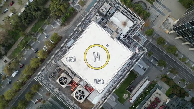 Descending Aerial Shot of a Rooftop Helipad in the Modern Urban Area of Santiago, Chile
