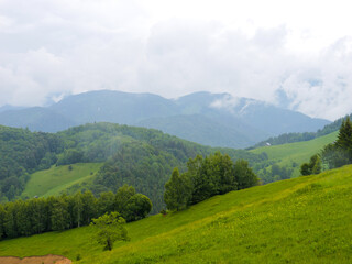 Mountain range at the west of Romania. Wonderful springtime landscape in mountains. Panorama of beautiful countryside of Romania.
