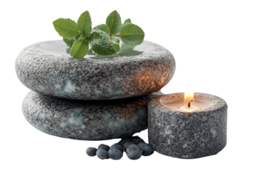 Serene arrangement of spa stones, a candle, and fresh mint leaves, perfect for relaxation and wellness themes.