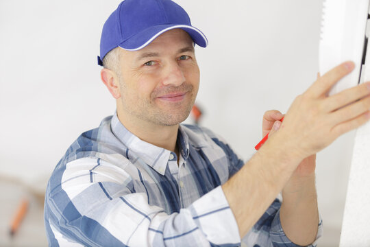 a hvac technician testing thermostat