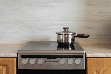 A saucepan stands on the hob in the kitchen