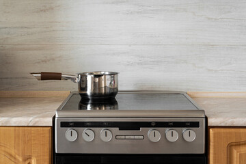 A saucepan stands on the hob in the kitchen
