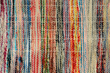 Obraz premium A close-up of a colorful, handcrafted rug woven from various recycled materials, showcasing its unique texture and vibrant patterns