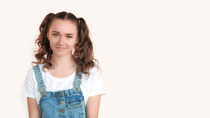 Happy girl. Carefree youth. Amused excited funny teen girl with 2 ponytails stands smiling isolated on white copy space background.