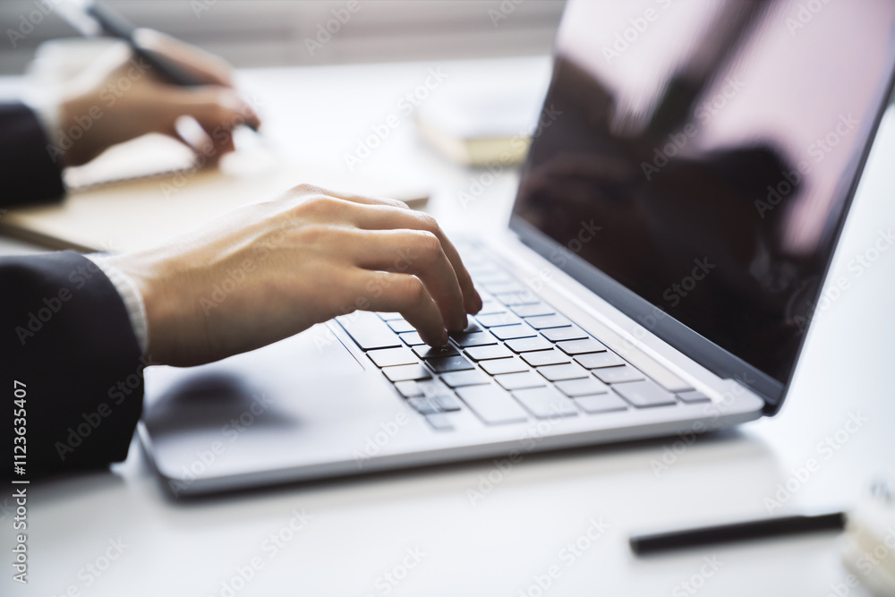 Poster a close observation of a woman's hands actively typing on a sleek laptop keyboard, set against a fuz