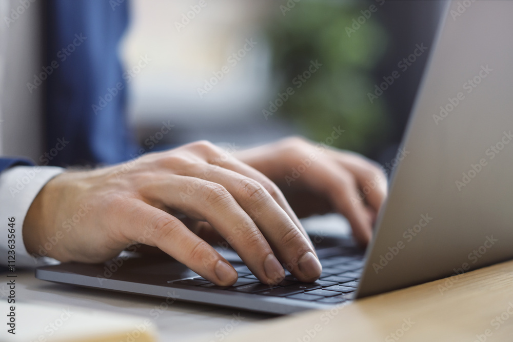 Poster the photo presents a close-up of a man's hands as they type on a cutting-edge laptop keyboard, again