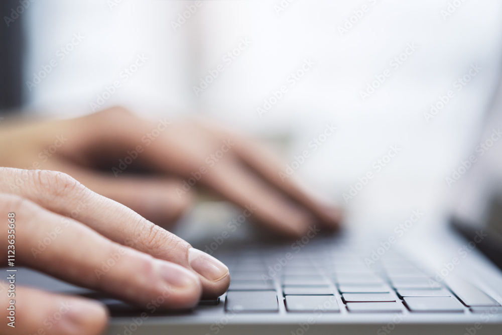 Poster the image presents a man's hands up close as they navigate a modern laptop's keyboard, against a blu