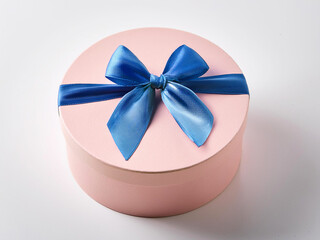 Round gift box with blue bow on white background