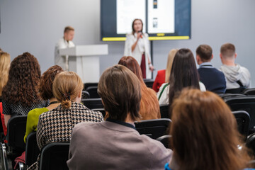 Attendees focus on speaker in professional environment. Ideal for illustrating corporate events,...