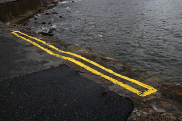 Short double yellow line on the harbour - Small fishing village of Crovie - Aberdeenshire - Scotland - UK © Collpicto