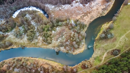 Steep bends and loops of Merkys river, from above, first snow, Merkine region, Lithuania. Dzukija...