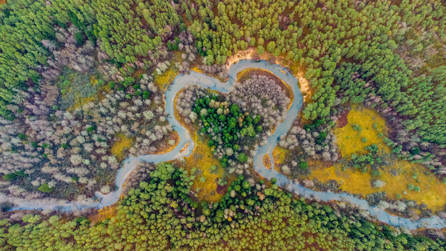Steep scarp and loops of the Ūla-Pelesa river, heart shape, from above, early winter, near the village of Žiūrai, Varėna district, Lithuania. Dzūkija National Park.