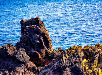 Basalt rocks on the coastline of the island of volcanic origin