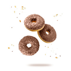 Three sweet donuts or doughnuts closeup in trendy color 2025 year Mocha Mousse flying isolated on...
