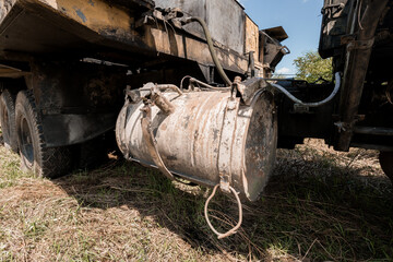 Rusty Equipment Hanging from a Truck on a Sunny Day
