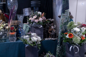 A floral arrangement for special occasions featuring soft lilac roses, eryngium, and fern foliage,...