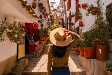 Latin tourist walking down 7 Borreguitos street in Cusco