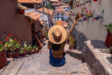 Latin tourist walking down 7 Borreguitos street in Cusco