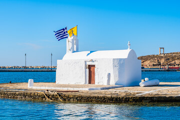 Small white Greek chapel on jetty in Naxos port, Naxos island, Cyclades, Greece