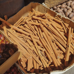 Box of cinnamon spices, nuts and dry fruits at mediterranian market