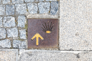 way of Saint James yellow arrow and the shell on the floor