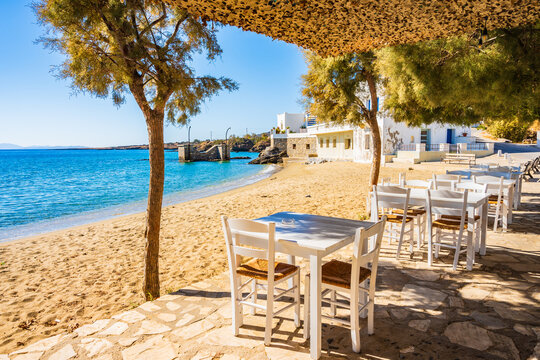 Fototapeta Tables with chairs in Greek taverna restaurant on beach in Motsouna village, Naxos island, Cyclades, Greece
