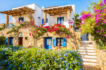 Typical Greek style apartments decorated with colorful flowers in Galini village, Naxos island,...