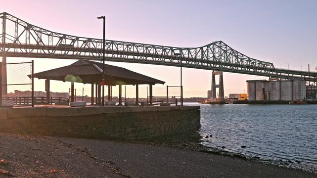 The architecture of Boston in Massachusetts, USA showcasing the iconic Tobin Bridge spanning over the Mystic river on a sunny morning at sunrise.