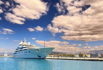 A luxuru yacht in the harbor under the bright sky 