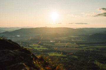 A stunning sunset over a valley with the sun shining through clouds
