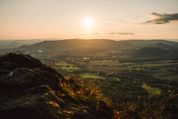 A stunning sunset over a valley with the sun shining through clouds