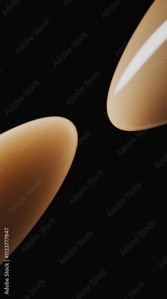 Poster two drops of liquid foundation are placed on a black background, creating a visually appealing contr
