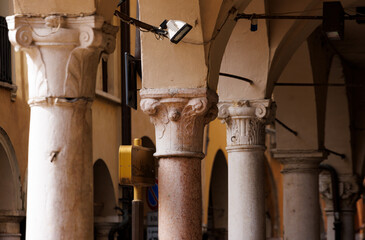 A scenic view of a colonnade with Corinthian capitals in the historic center of Mantova