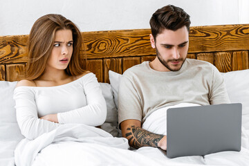 Boredom and jealousy in family at home at covid-19 quarantine and social issue. Sad young wife...