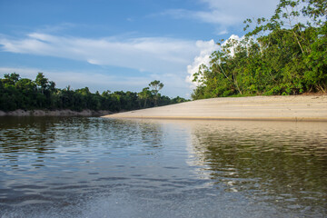 IGAPOS OF THE NANAY RIVER, BLACK WATERS THAT REFLECT THE CLOUDS ON THEIR SURFACE