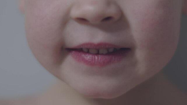 Boy smiles brightly wobbly milk tooth joy of carefree childhood and charm of youthful change. Close-up of child's smile loose milk tooth visible carefree nature of childhood natural progression