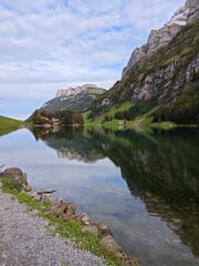 A clear lake in a swiss alp mountain during a cloudy evening in september