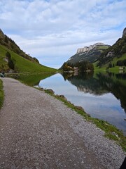 A clear lake in a swiss alp mountain during a cloudy evening in september
