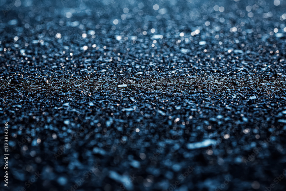 Poster blurry image of a dark surface with a few specks of light. the image has a moody and mysterious feel