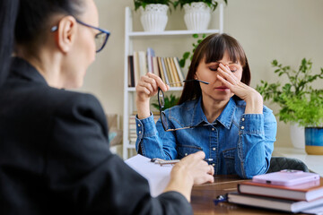 Woman patient in emotional stress at therapy meeting with psychologist