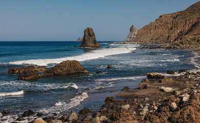 A picturesque coastal scene with rocky formations, gentle waves - obrazy, fototapety, plakaty