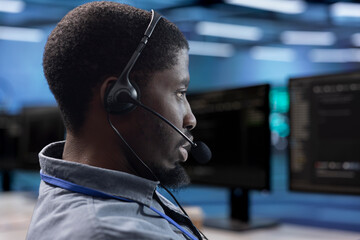 Employee working in call center sitting at PC desk and providing outsourcing services for data...