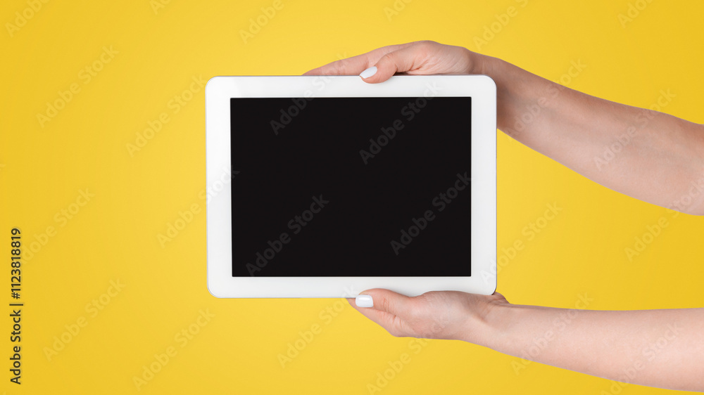 Poster Closeup of girl holdng tablet computer with empty screen on light background, mockup for design