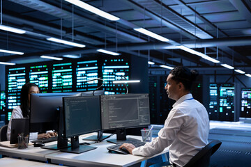 Engineering coworkers in data center looking for firewall misconfigurations affecting servers. IT...