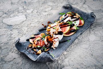 Traditional Greek goats cheese gratinated with sliced figs, pine nuts and balsamic served as...
