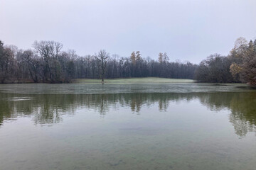 Fototapeta premium Mystery morning foggy park in the Nymphenburg Palace in Munich, Germany