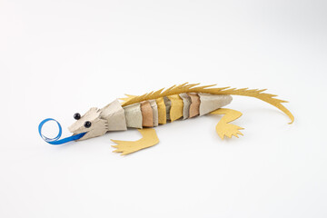 a colorful lizard from recycled cardboard and paper. DIY eco-friendly craft project with...